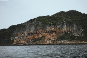  A solitary rock formation stands tall in the ocean waters off the coast of Guimaras, Philippines.