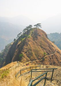 Wide shot from the top of the 'Stairway to Heaven' in Mt. Kabunian, revealing rugged peaks, misty valleys, and stone steps descending into the clouds below.
