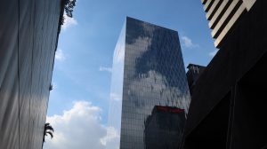 A building with glass windows with the blue sky as background