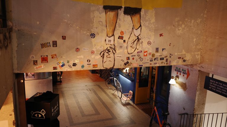 A mural depicting a person’s feet painted on a wall, showcasing artistic expression and urban creativity.