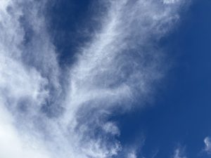 Wispy white clouds in a blue sky.