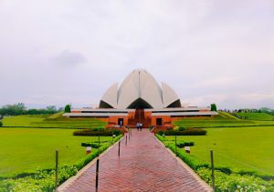 Beautiful morning view of the Lotus Temple in New Delhi, India, surrounded by greenery.