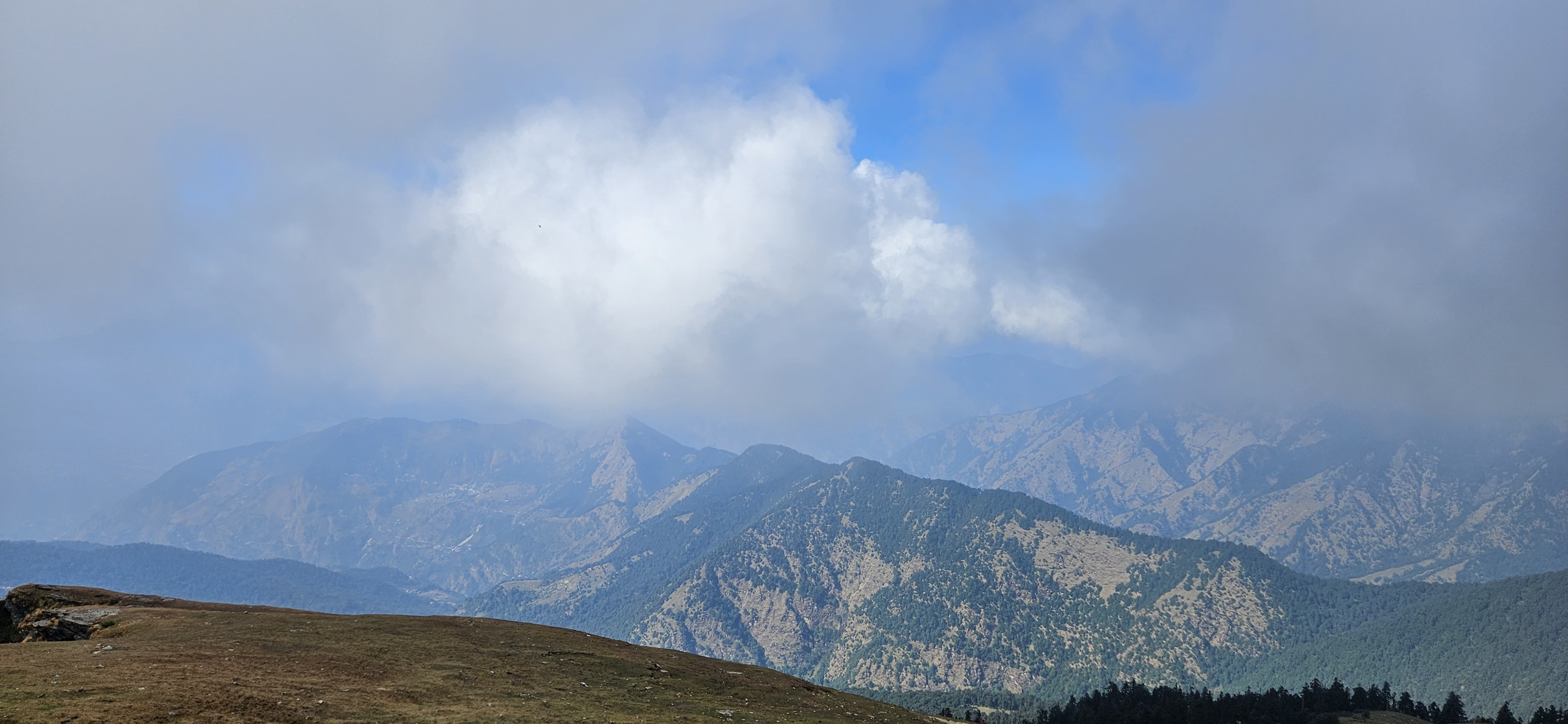 Aerial view of a mountain surrounded by sky