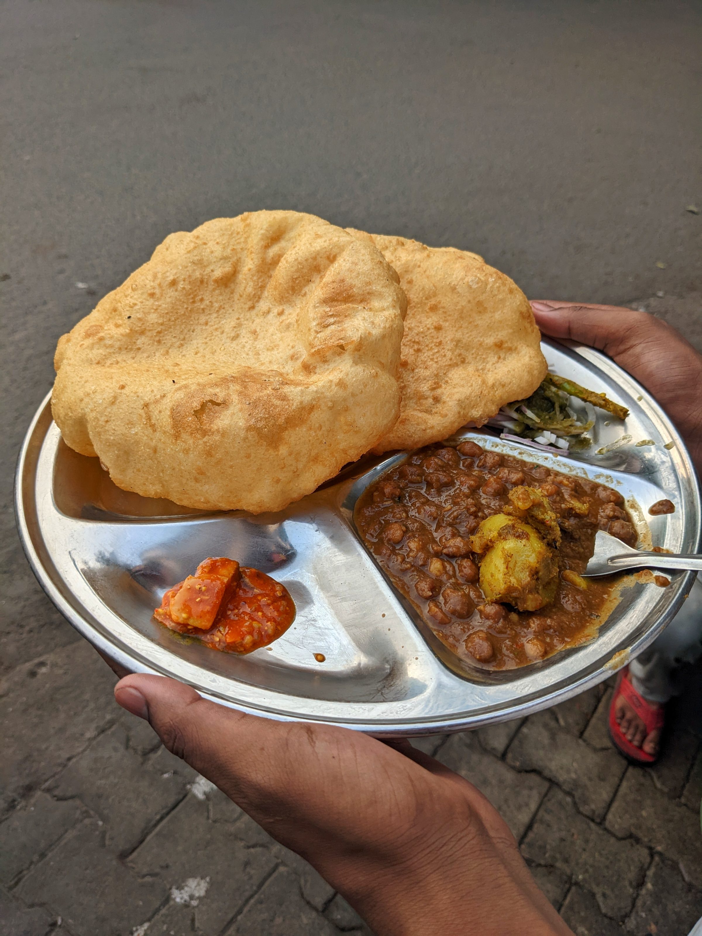 Chhole Bhature Delhi with Red Spicy Pickles, and Some Salad like Onion and Chillies