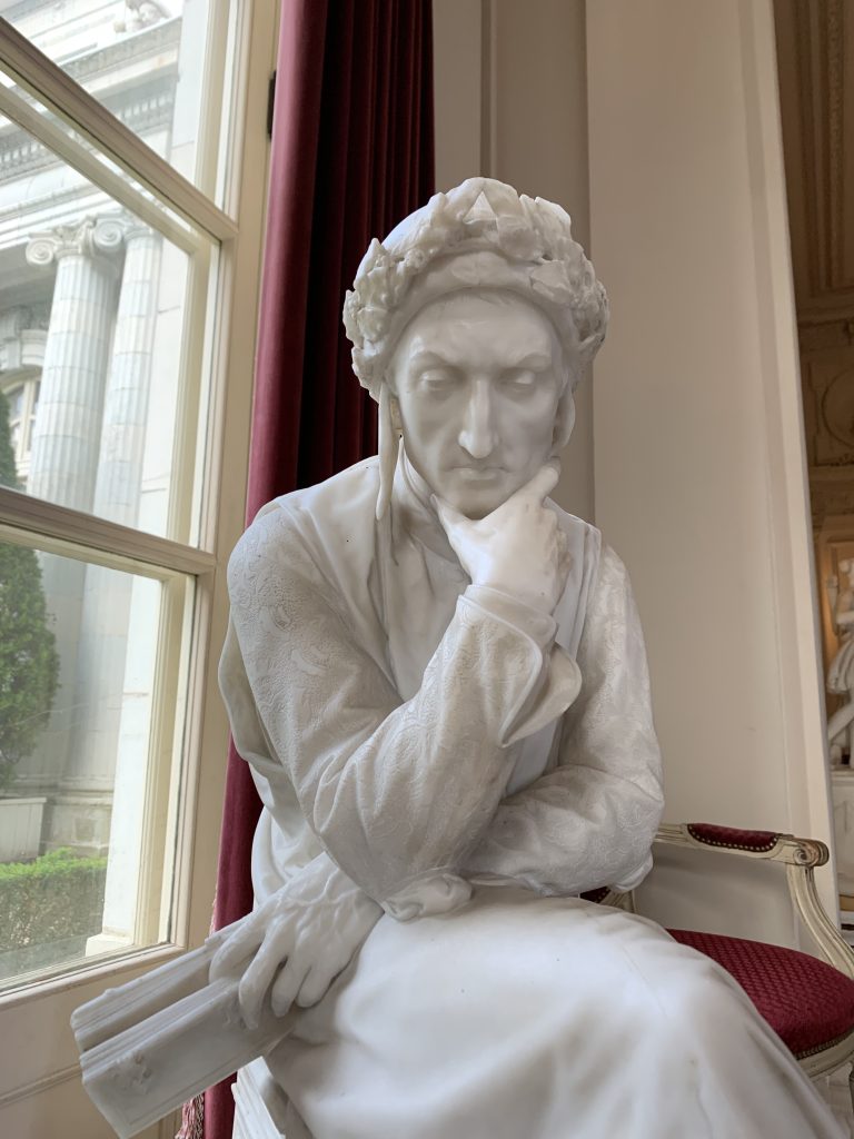 A granite statue of a man thinking at the Rosecliff Mansion in Newport, Rhode Island.