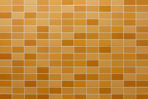 A grid of orange and yellow ceramic tiles arranged in a geometric pattern.