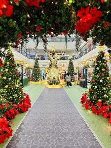 Well-decorated Christmas tree in a shopping mall in Malaysia. Visitors are watching the Christmas tree.