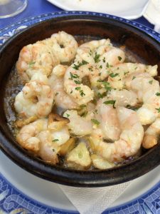 Traditional dish of Spanish cuisine, garlic prawns, served in a clay pot
