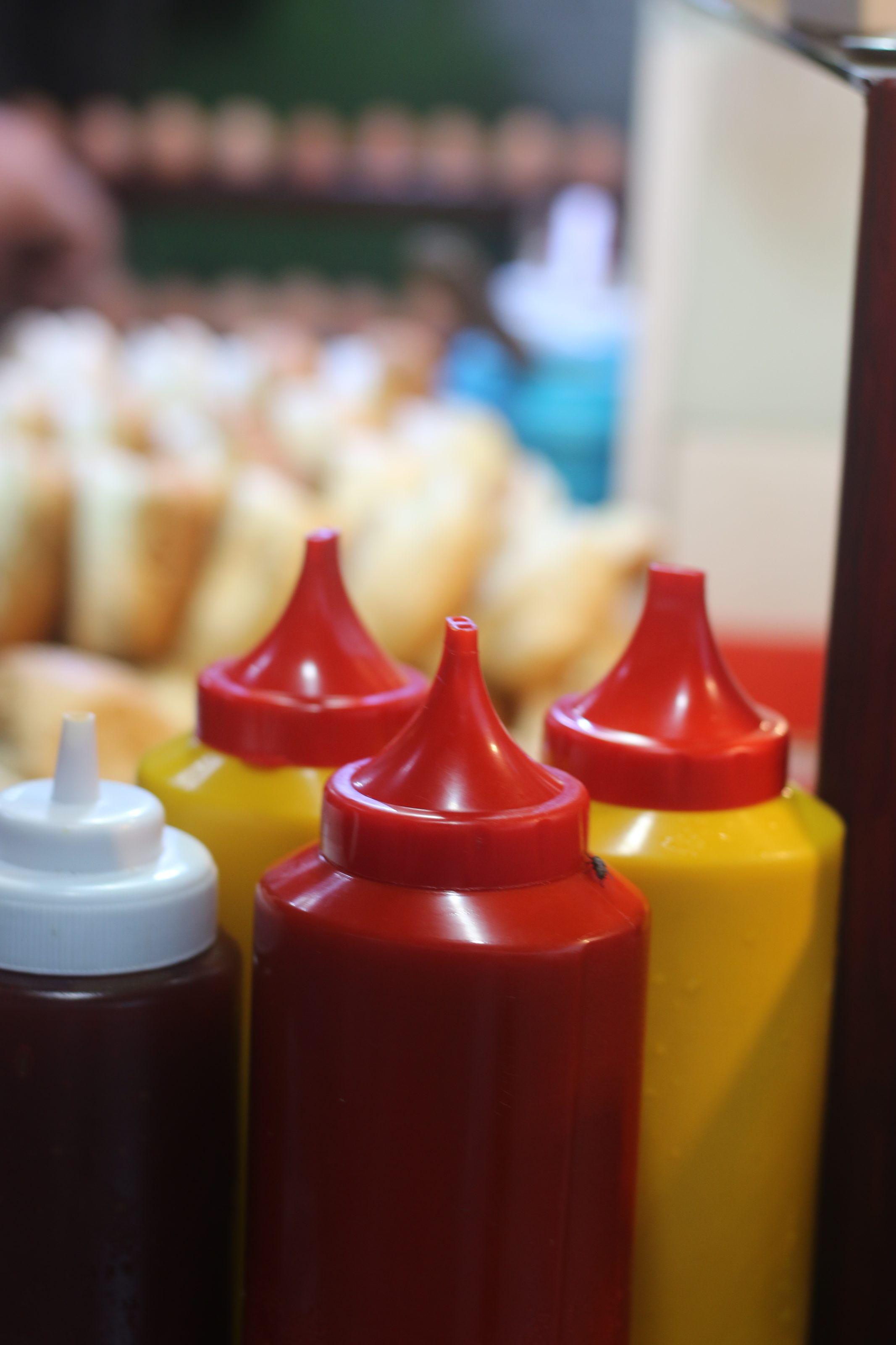 A close-up view of hot dogs topped with vibrant red ketchup, showcasing their appetizing appearance.