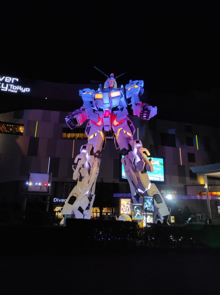 A Gundam displaying in front of a mall in Japan