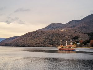 A pirate ship in a lake surrounded by mountains