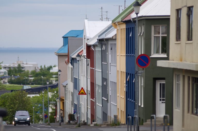 A street in Reykjavík on a slope with many different colored houses.