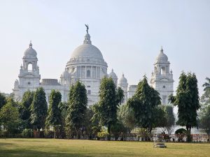 A serene view of the Victoria Memorial, Kolkata surrounded by lush gardens and greenery