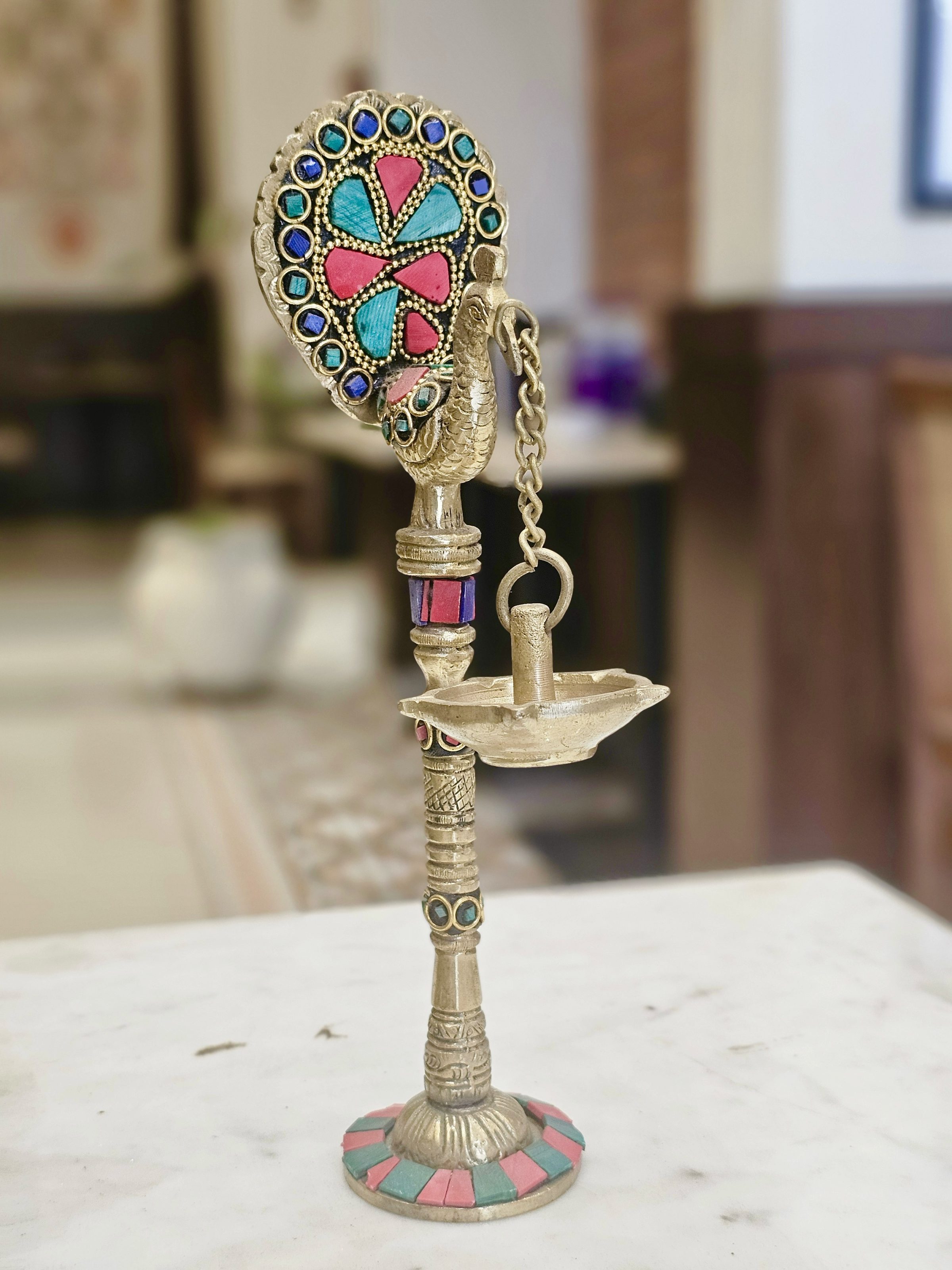 Close up of well decorated traditional peacock lamp. From a restaurant, Pune, Maharashtra.
