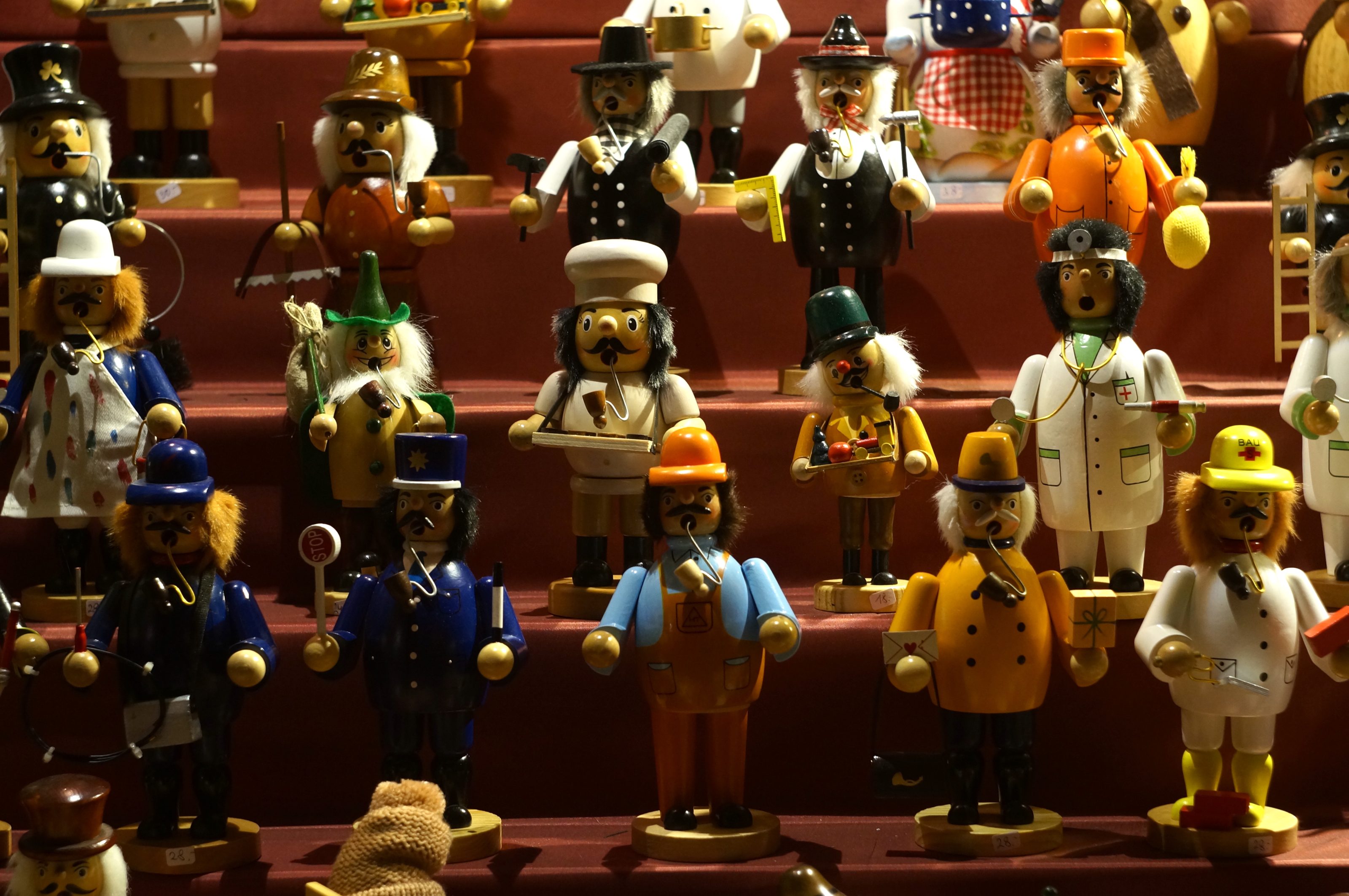 Showcase of traditional wooden dolls of different professions.