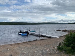 A boat sits awaiting its crew on the shore of Gambo Pond, Newfoundland, Canada.