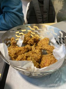 Crispy fried chicken pieces in a metal basket, ready to be enjoyed.