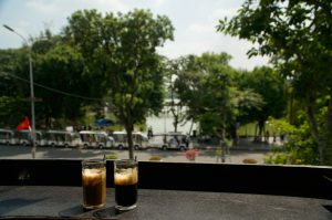 Two glasses of coffee in a window at a cafe in hanoi, Vietnam.