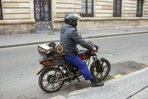 Traditional spanish "afilador". A man drives a motorcycle with a whetstone fixed to the back to sharpen knives and scissors door to door.