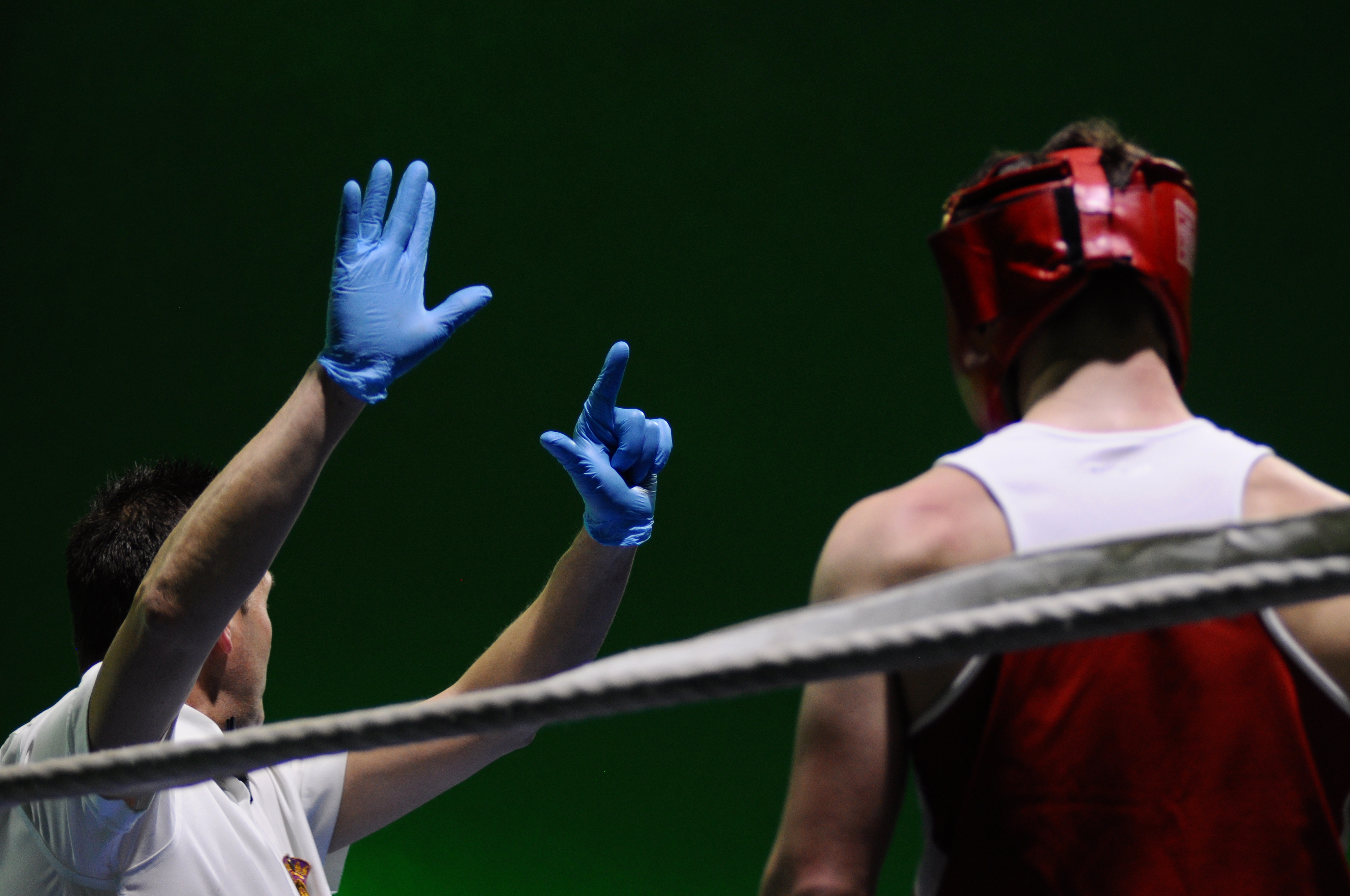 A boxing referee making inquiries to one of the boxers during a training bout.