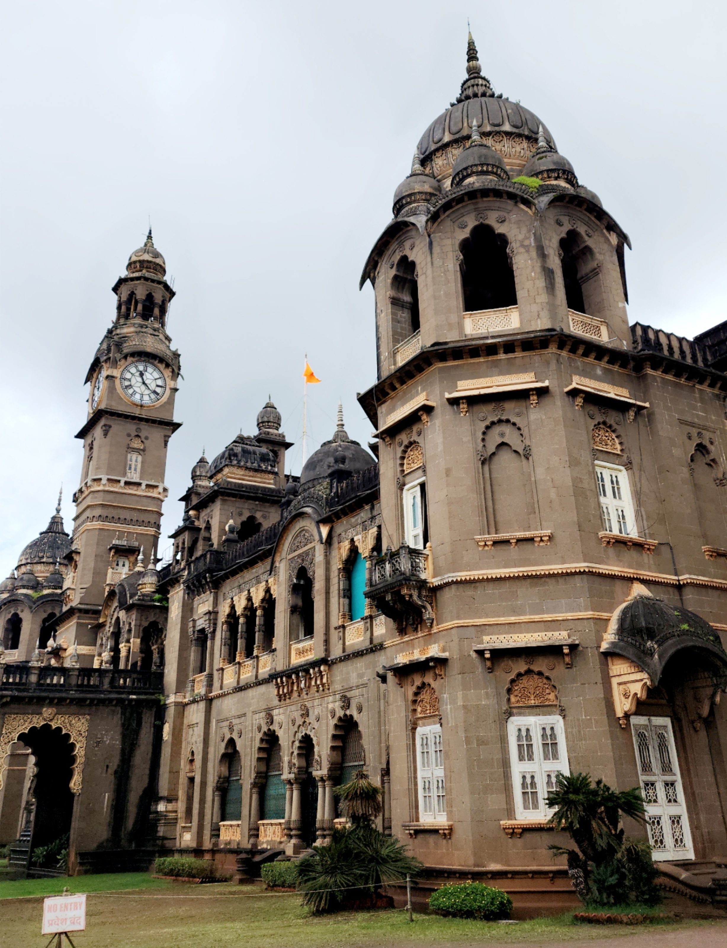 Historic building with ornate architecture, featuring a large dome and a clock tower. The structure includes intricate carvings and arched windows.