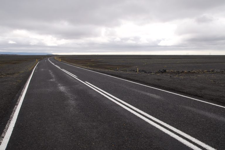 A dark road in an Icelandic volcanic landscape