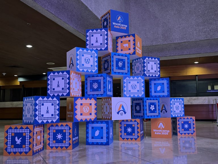 A stack of boxes with different elements and logo of WordCamp 2025.