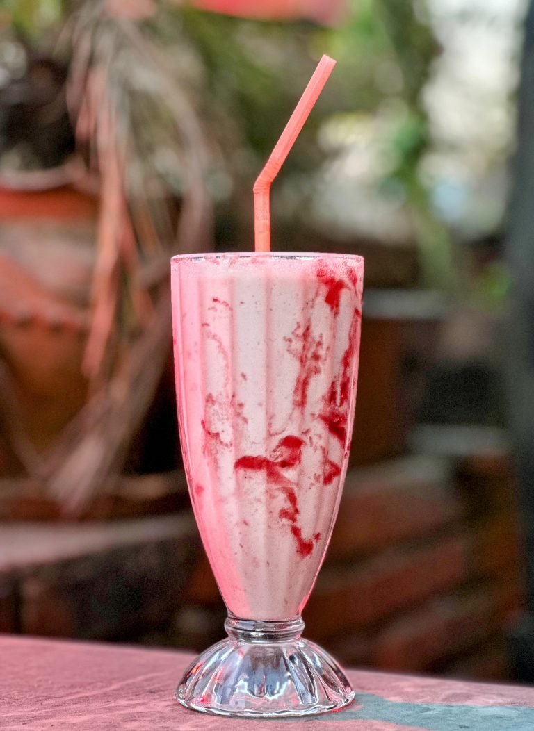 Strawberry smoothie with a straw.