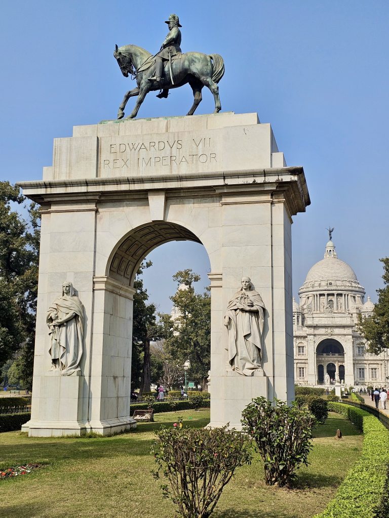 A view of the Edward VII memorial arch with the Victoria Memorial in the background, Kolkata.