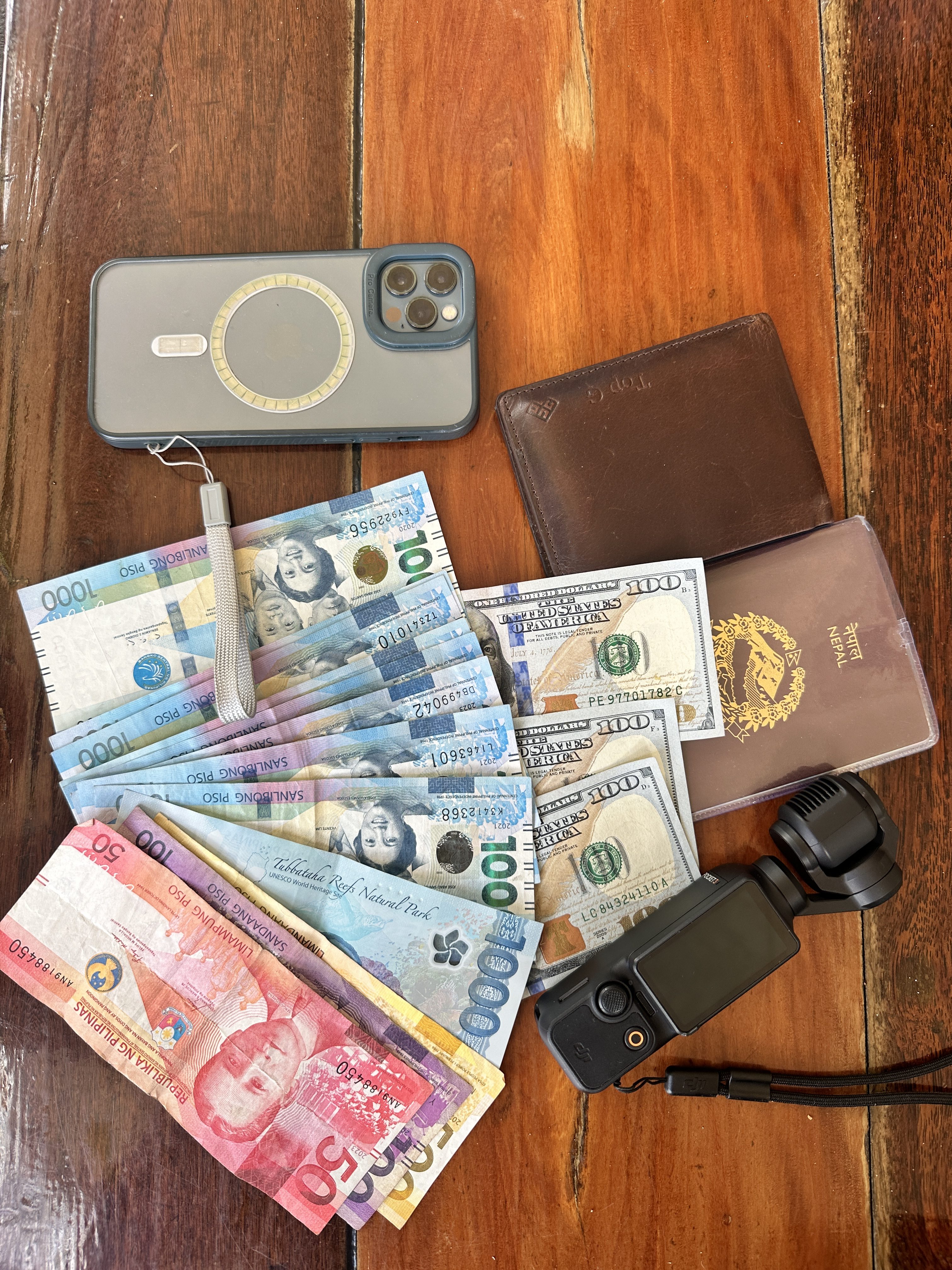 A traveler with some Peso, USD, iPhone, camera. These are the essentials for a traveller. 