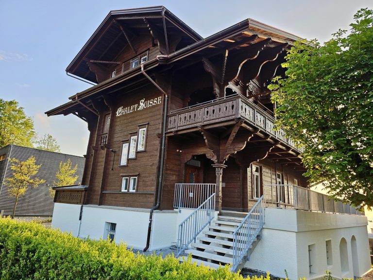 A traditional Swiss Chalet style building designs with widely projecting roofs and facades decorated with wooden balconies and carved ornaments. It is part of Institute Montana, Zugerberg, Switzerland.