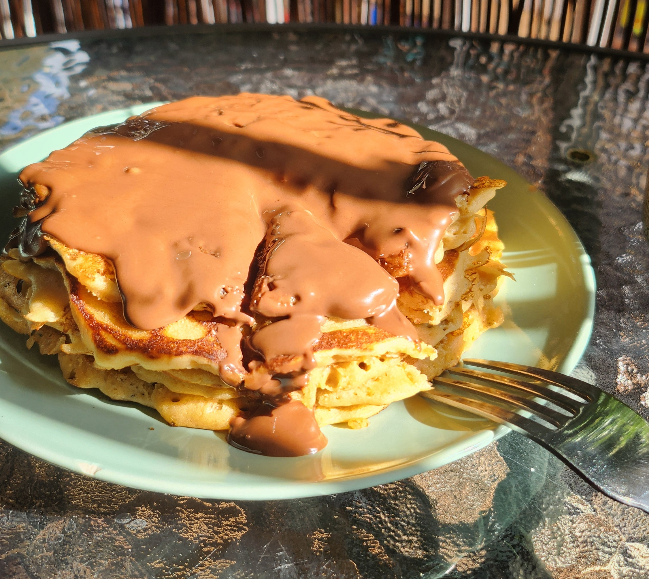 a plate with chocolate pancakes and a fork