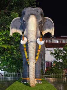 Night view of majestic statue of Guruvayur Keshavan, the legendary elephant of Guruvayur Temple, adorned with garlands