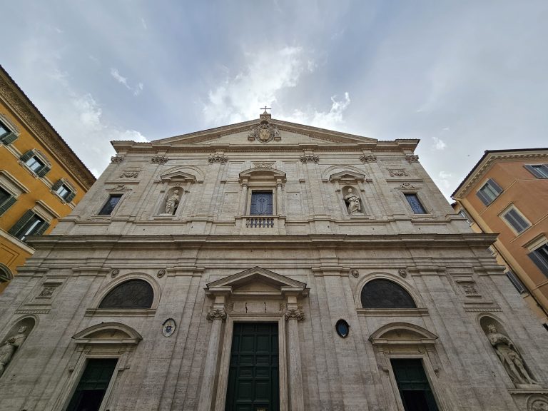 The facade of the church of San Luigi dei Francesi in Rome. The facade is made of travertine and is divided into two orders, with the upper order smaller than the lower one