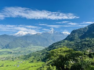Fishtail mountain with greenery hills.
