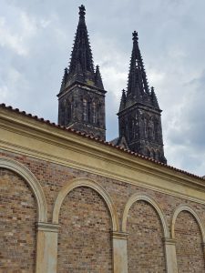 The bell towers and a section of the outer wall of Basilica of St. Peter and St. Paul in Vyšehrad, Prague, Czech Republic.