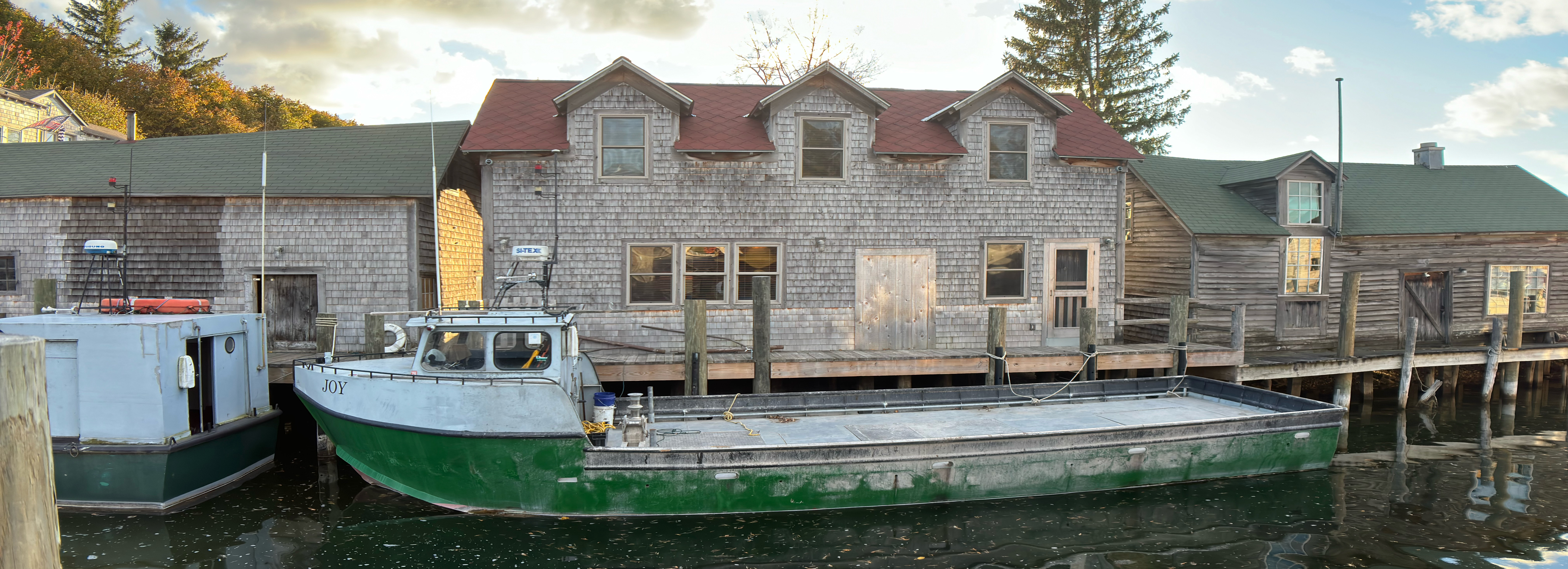 Fishing boat on a riverbank next to a fishing hut in Leelanau, MI.