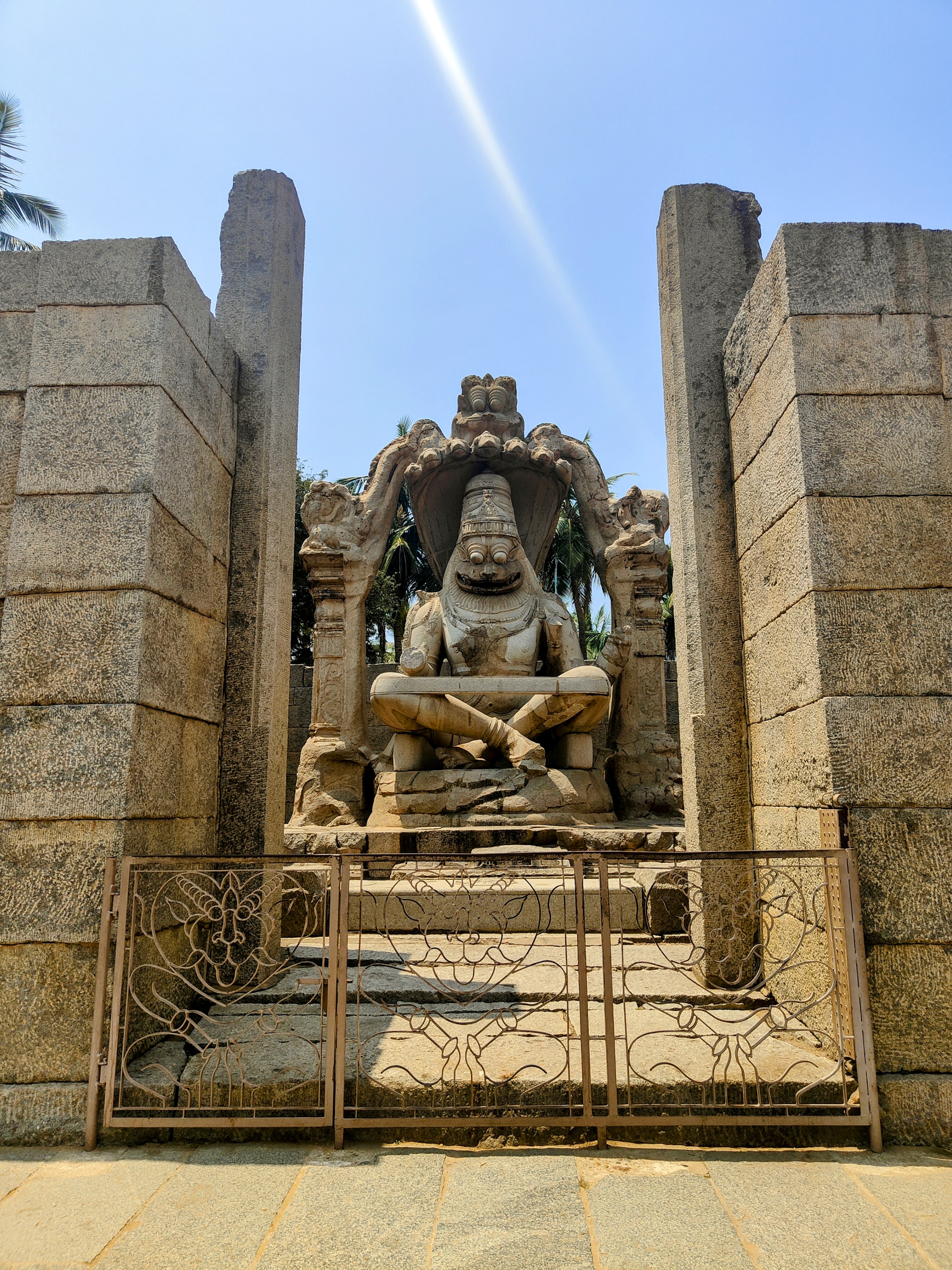 The Ugra Narasimha statue in Hampi is a massive monolithic sculpture of Lord Narasimha, an avatar of Vishnu, seated fiercely under the hood of the serpent Adishesha. Built in 1528 AD during the Vijayanagara Empire, it's one of Hampi's most iconic and powerful representations.