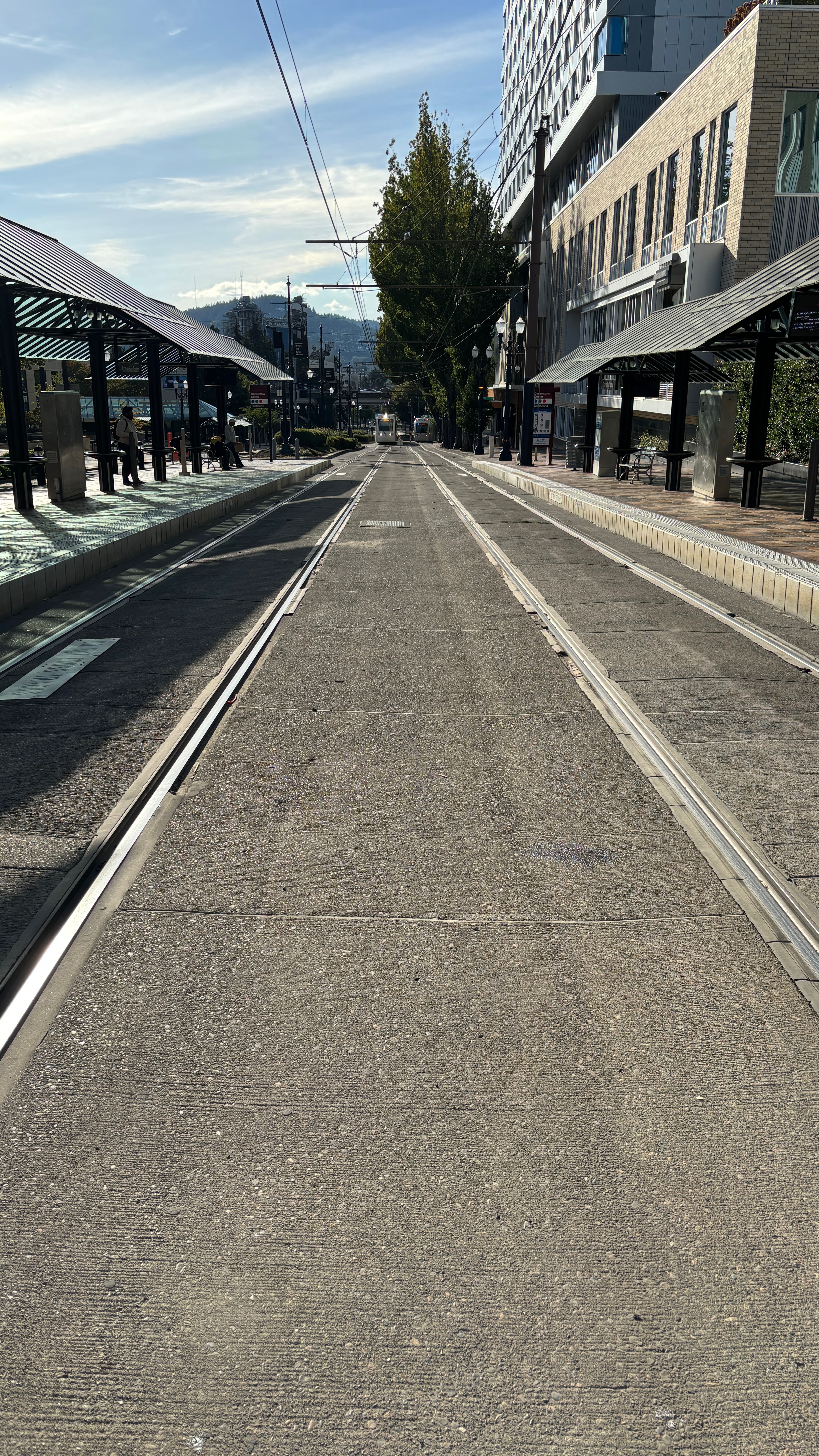 Train tracks in a city, going off into the distance.
