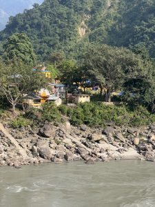 Hindu Temple premises on the bank of a river and surrounded by jungle. Staircase helps pilgrims to reach the river where they take bath before worshiping the temple. 