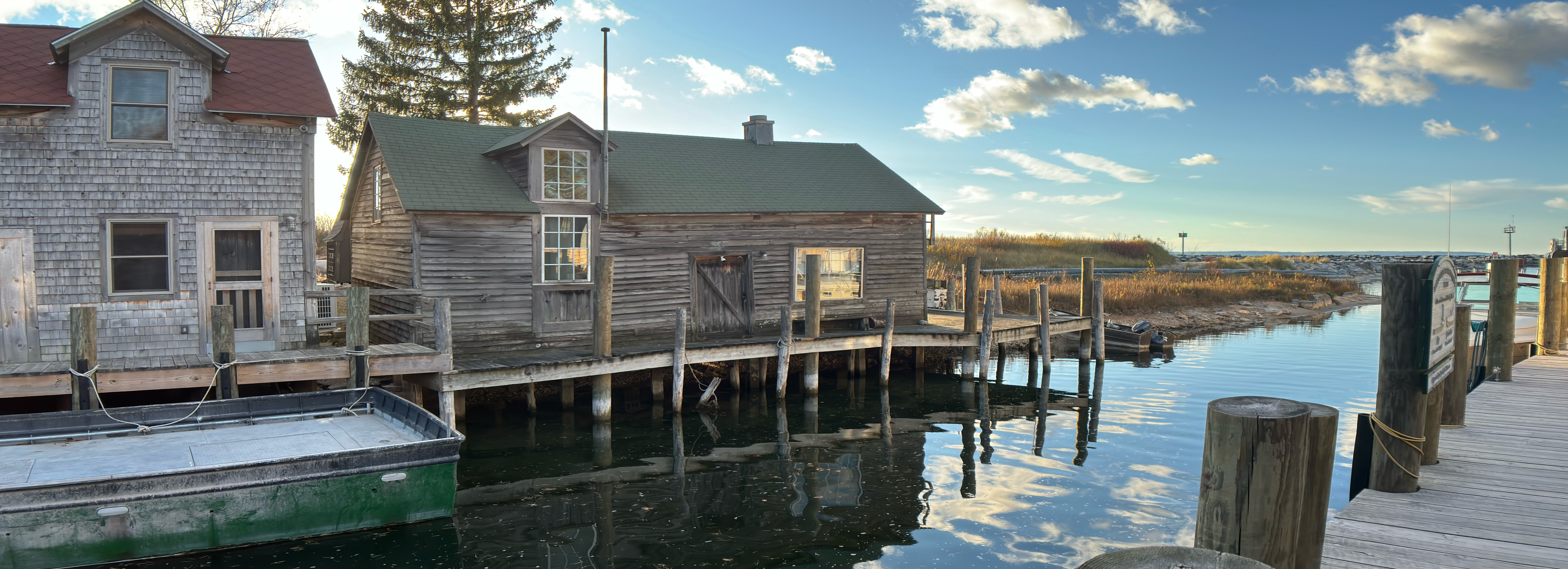 A fishing hut on the bank of the river going out into the bay in leelanau, mi.