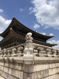 A traditional Asian building features a curved roof adorned with intricate designs and vibrant colors.