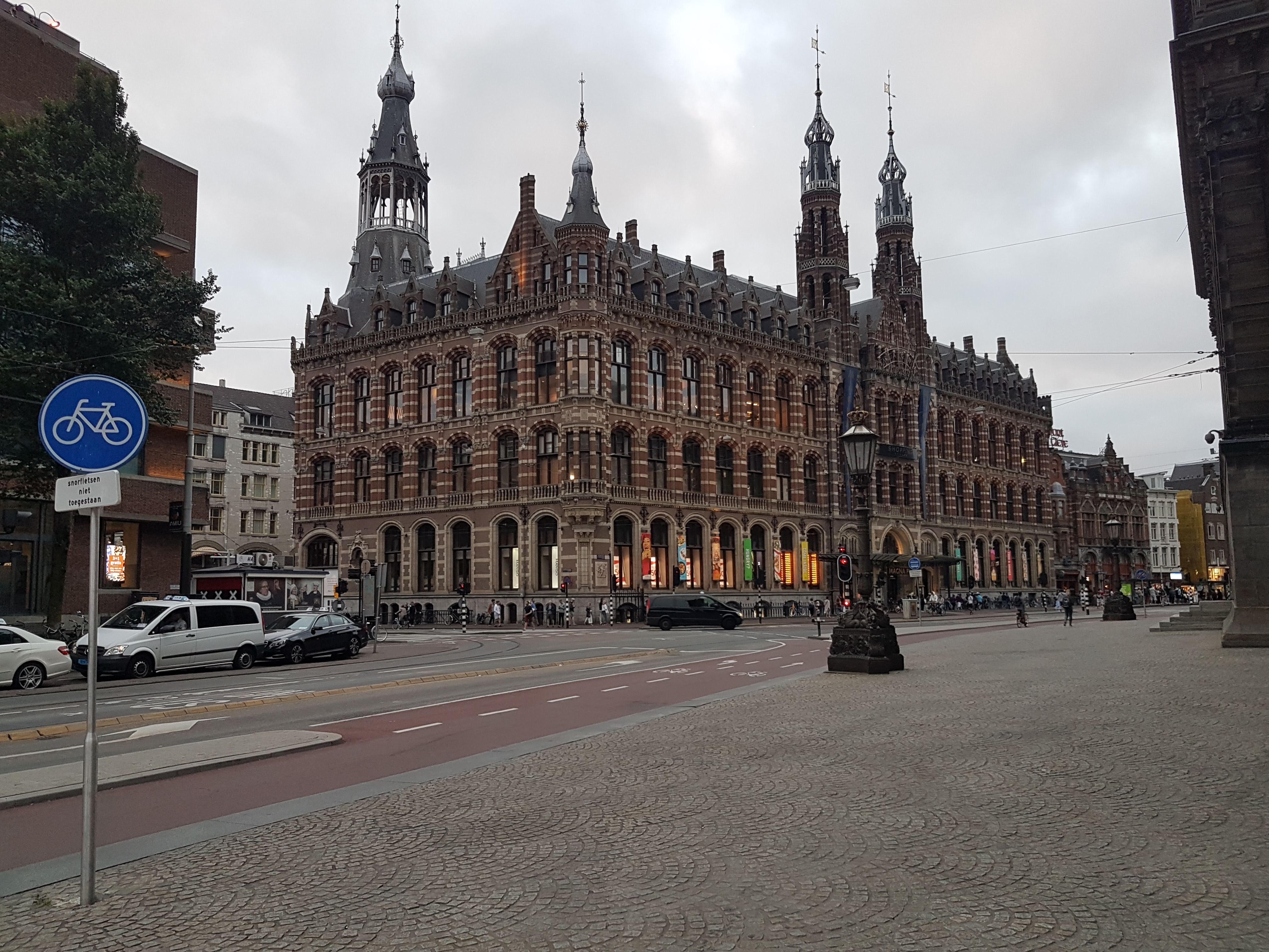 A large, ornate, historic building with intricate architectural details under a cloudy sky.