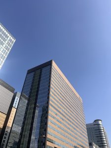 A modern urban landscape featuring tall buildings with glass facades