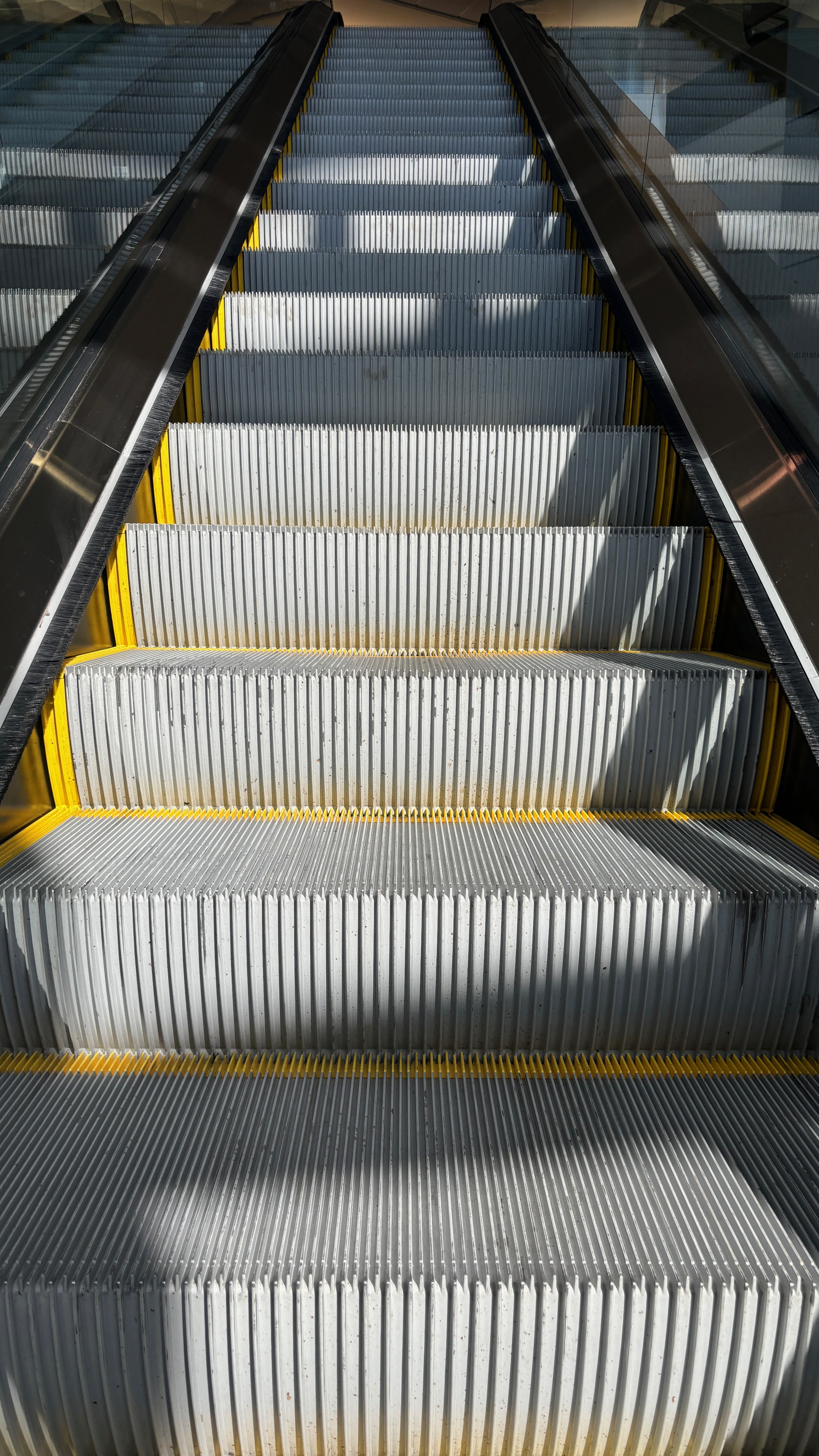 An escalator rising to an upper floor.