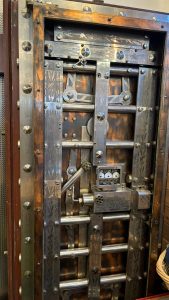 View of the inside of a bank vault door, showing its complicated workings.