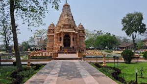 

A beautifully ornate CG temple with intricate carvings, standing amidst a lush green garden. 