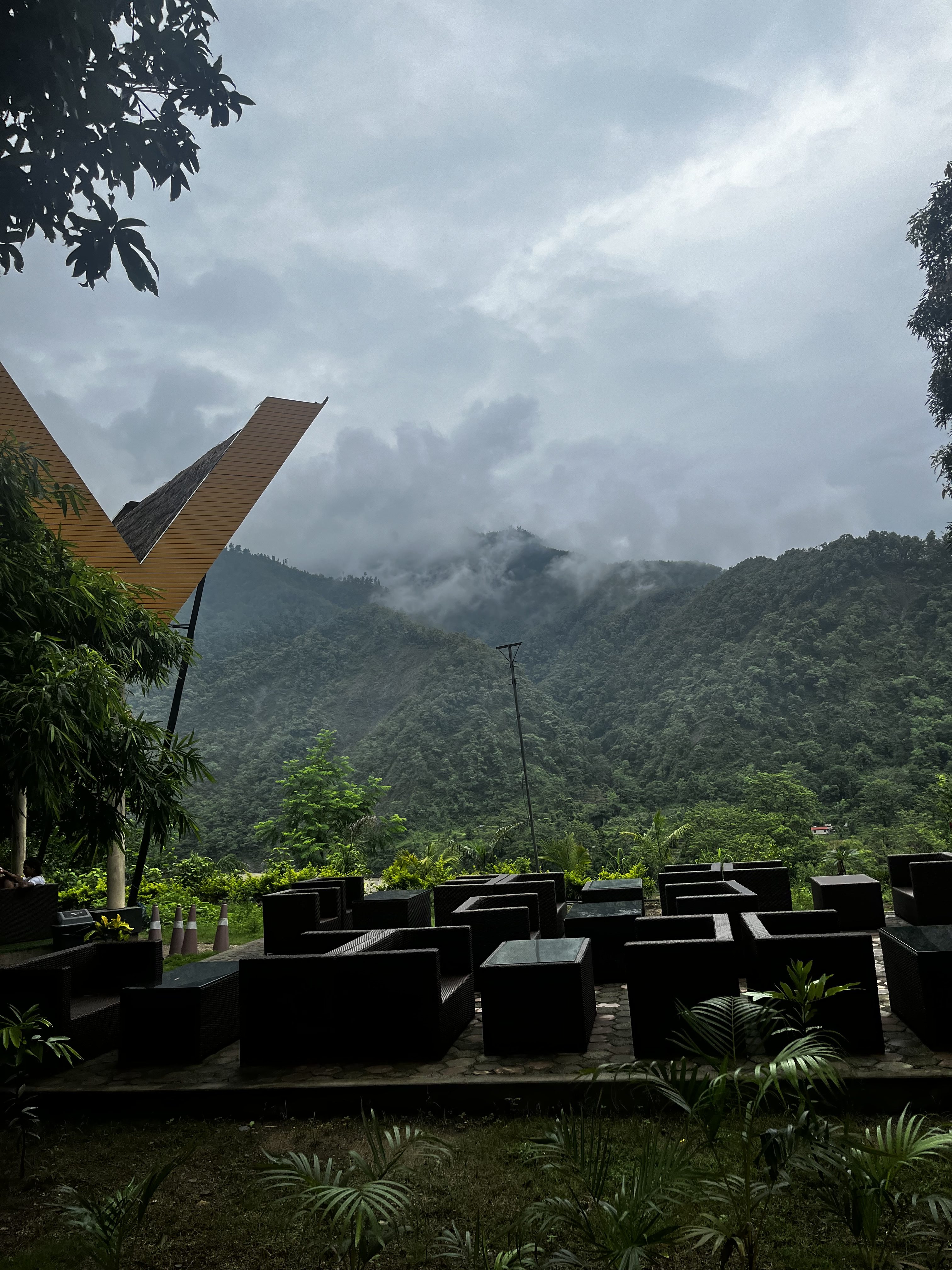 A scenic view of a mountain range seen from a comfortable lounge chair, highlighting the natural beauty of the landscape.