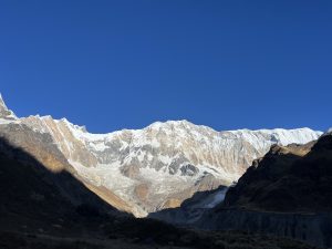 Majestic view of the Annapurna mountain range, shining under the clear blue sky in Nepal.
