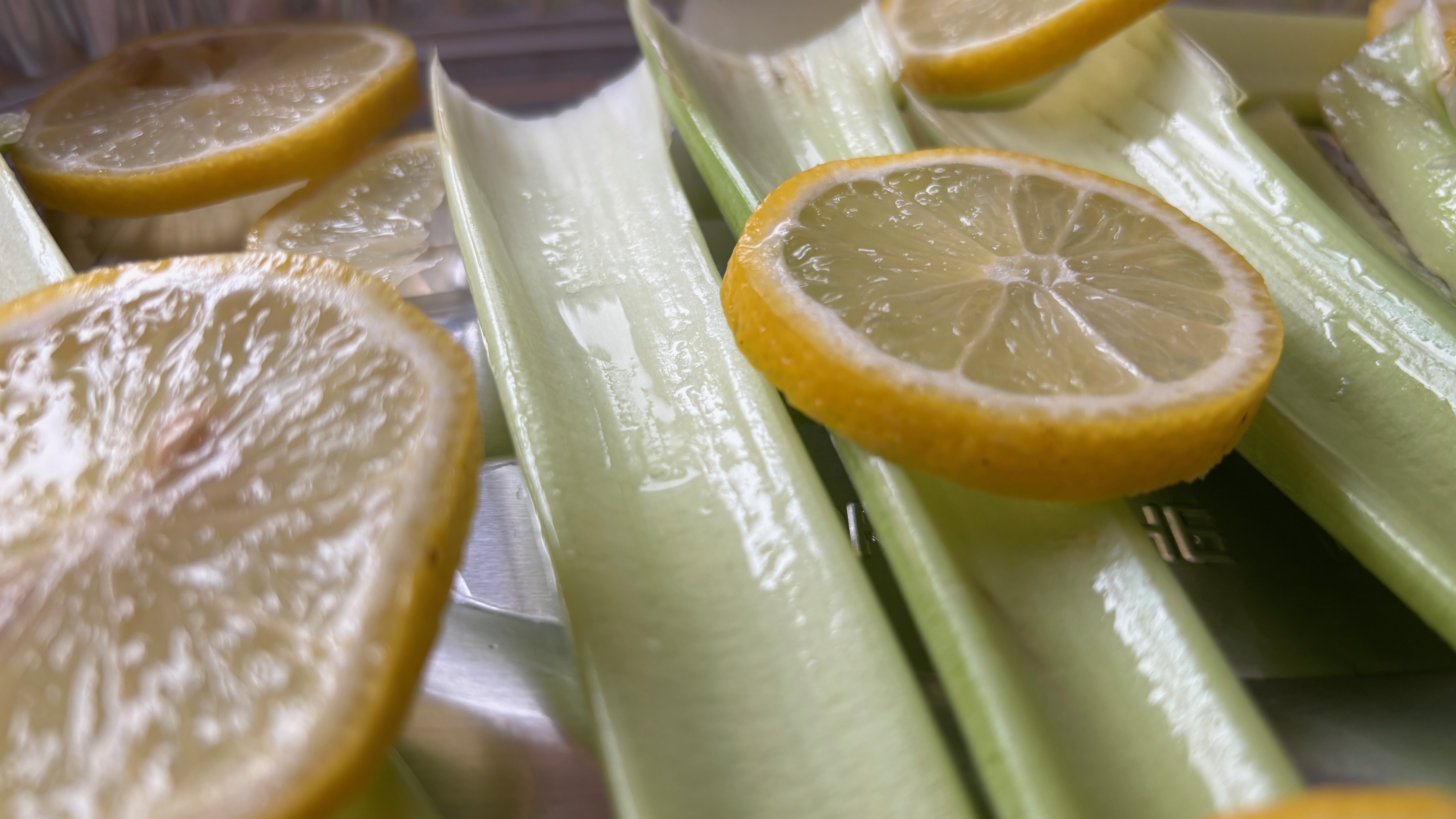 Lemons and celery prepared to be a base for cooking.
